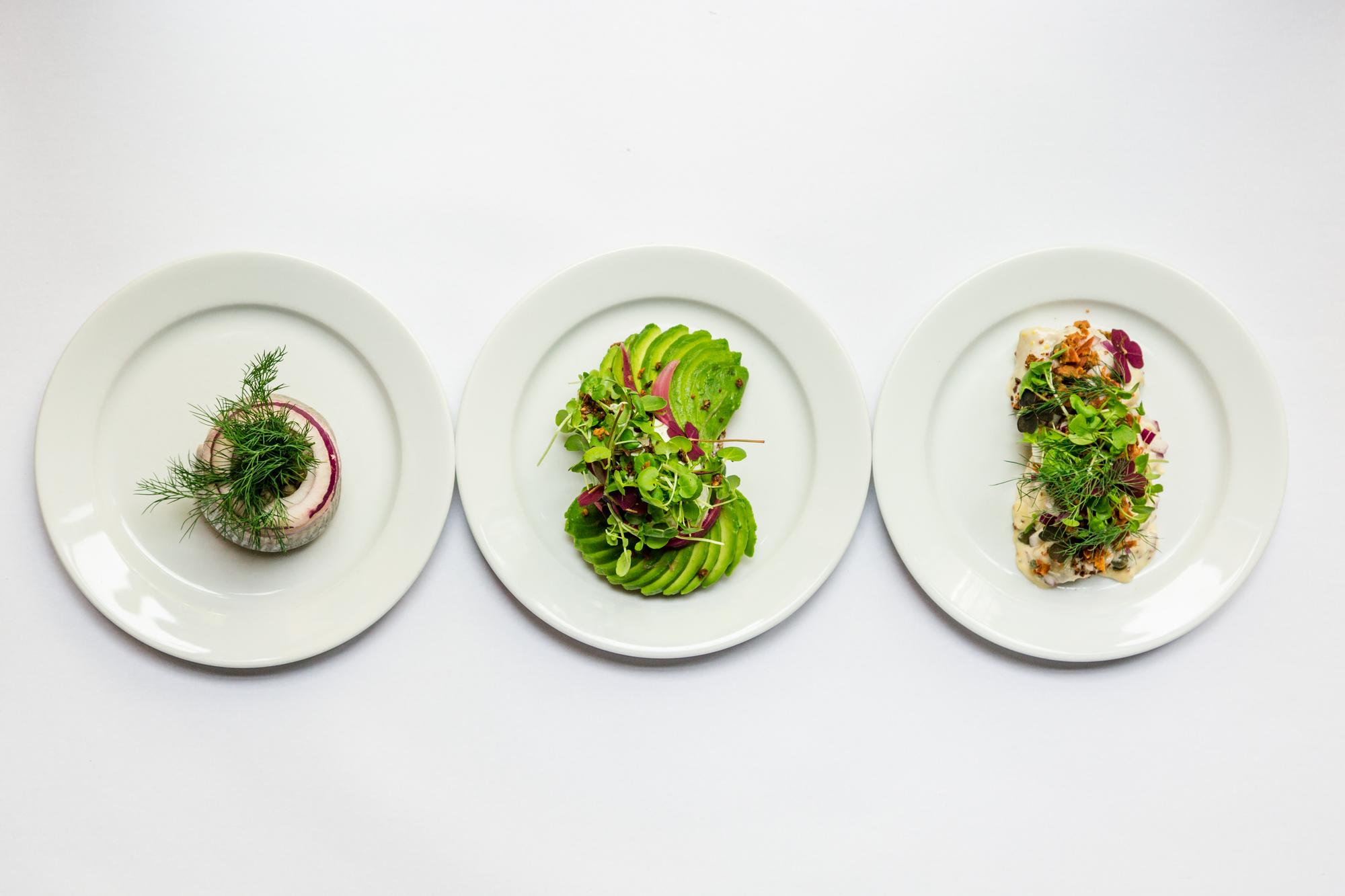 Three plated dishes representing course levels